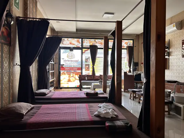 Curtained Thai massage mats facing a street-side window at Ai Oon Massage Lanna in Chiang Mai