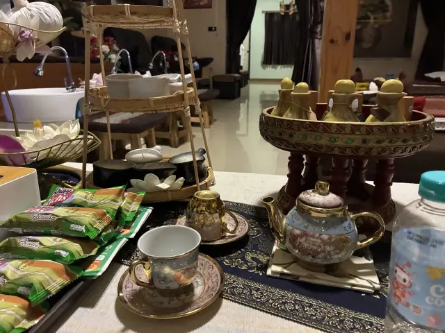 Welcome table with a teapot, tea bags and snacks beside the foot-wash area, Chiang Mai