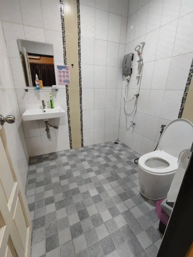 Clean tiled shower and toilet room for guests at Ai Oon Massage Lanna in Chiang Mai